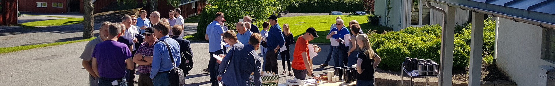 The picture shows a lot of people outside attending a research project presentation